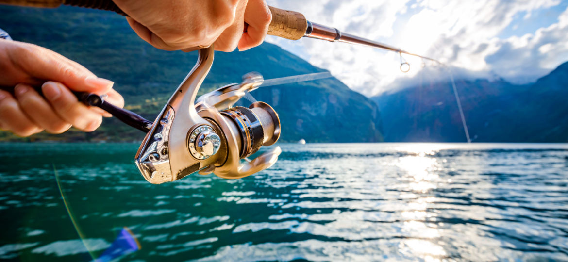 Woman fishing on Fishing rod spinning in Norway.